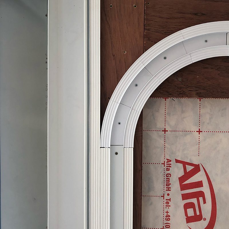 Curved TrackTrim sections fixed to ceiling framing before drywall