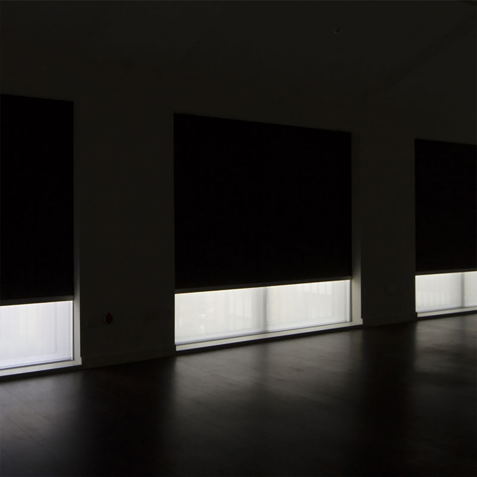 Media room with fully recessed blackout shades lowered over the windows