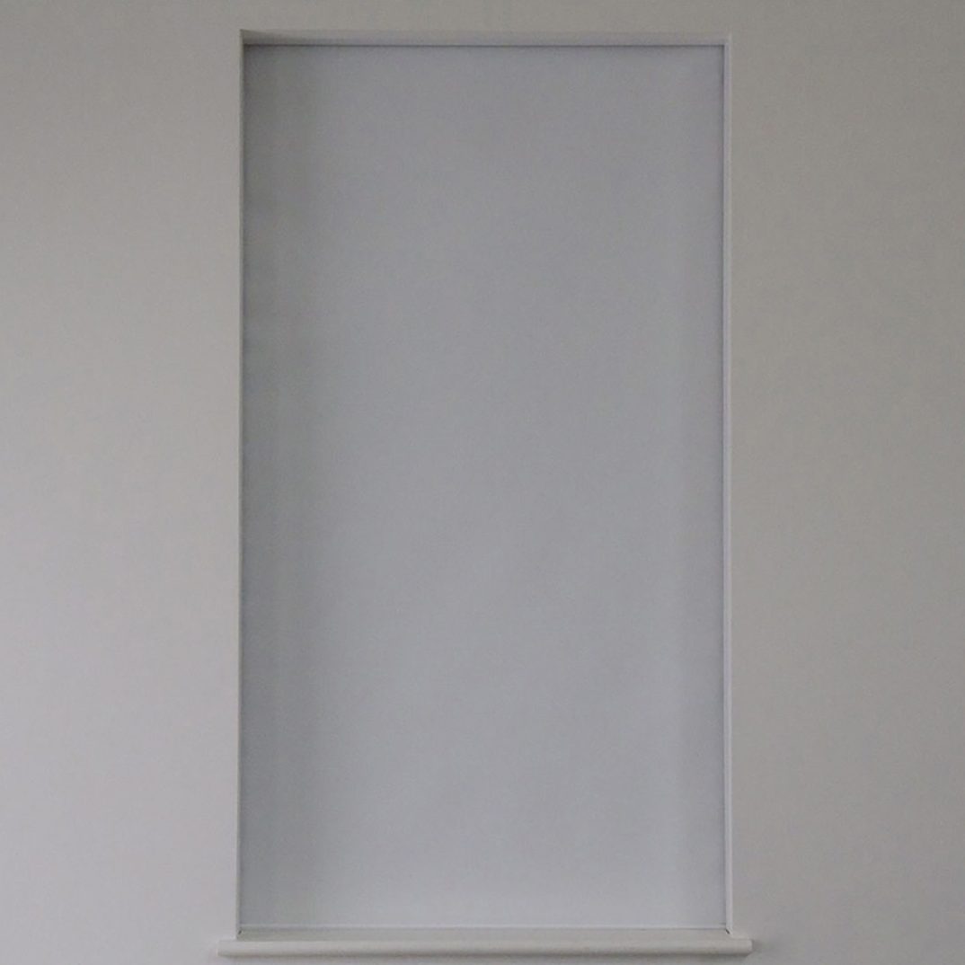 Window with a roller shade fully lowered from a concealed head box, Blindspace supplier photo
