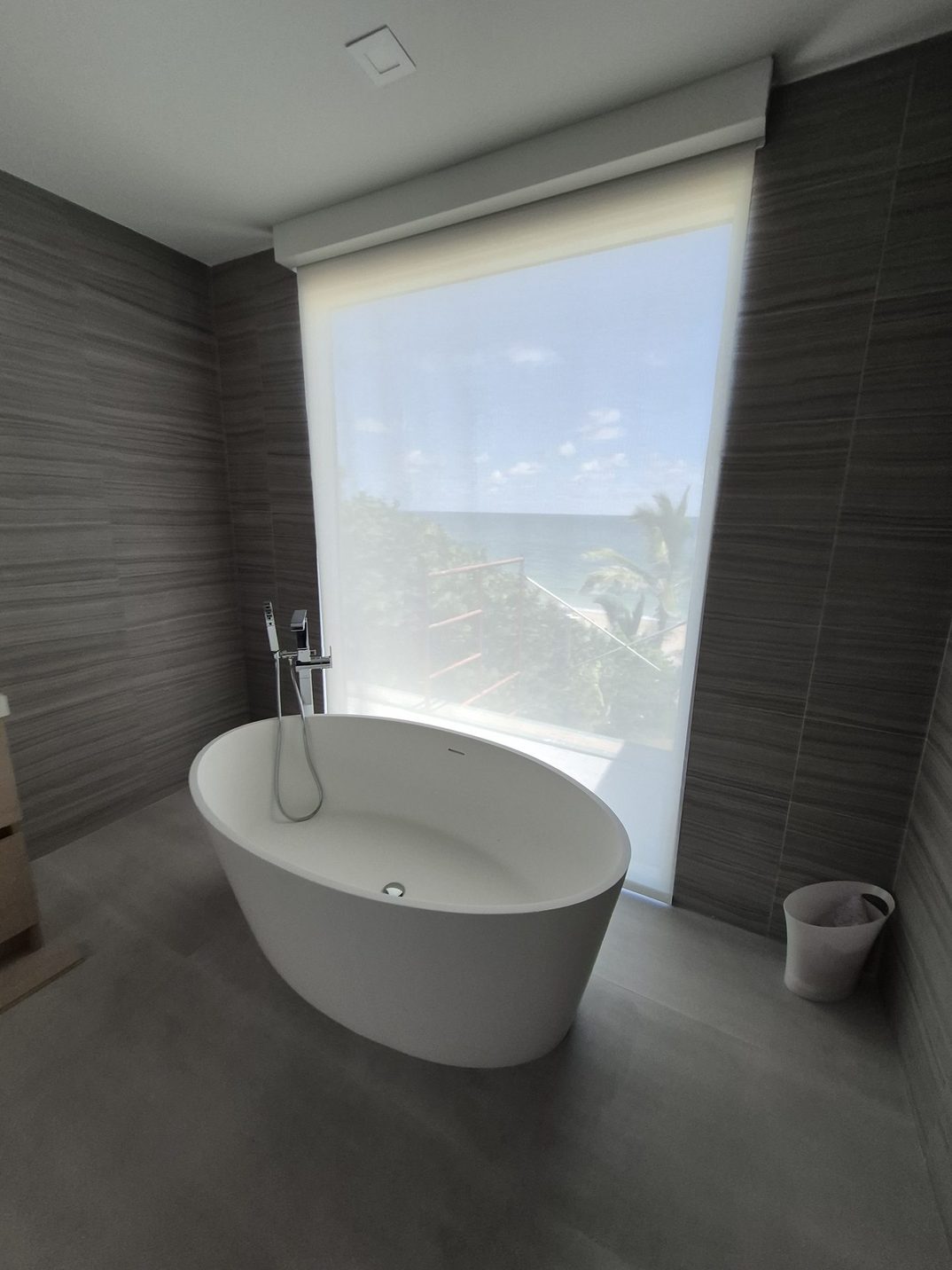 Motorized shade in a Miami bathroom