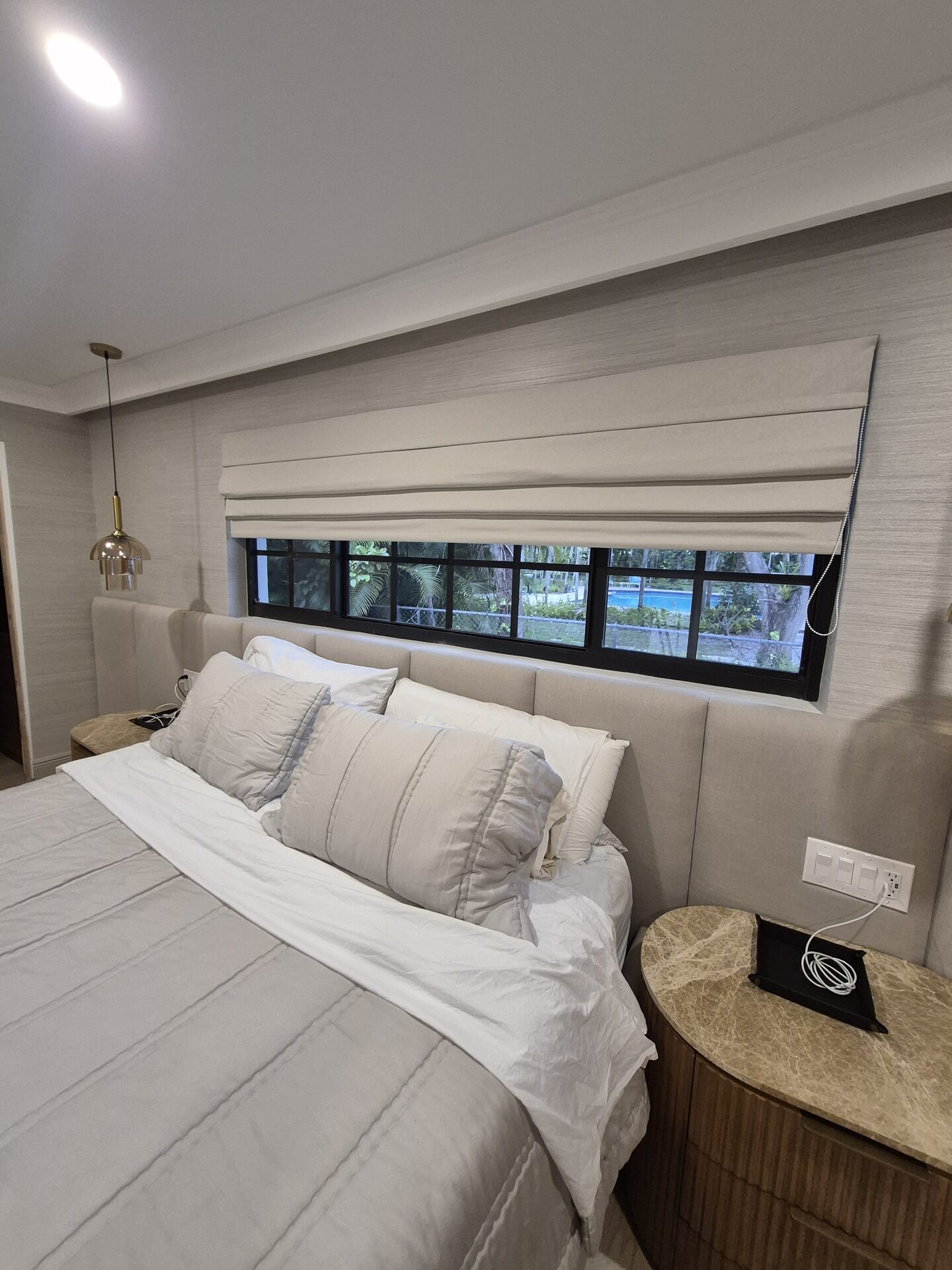 Bedroom shades installed above a headboard wall
