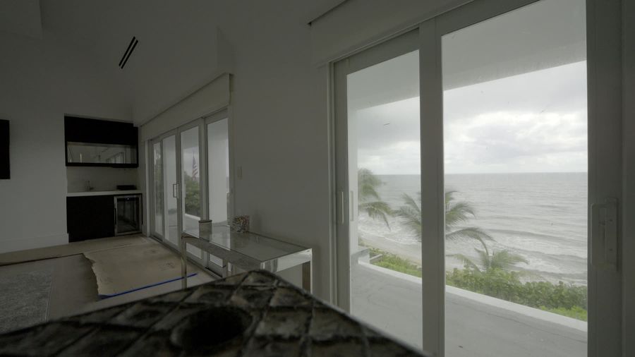 Motorized solar shades on the kitchen and dining ocean wall, Hillsboro Beach