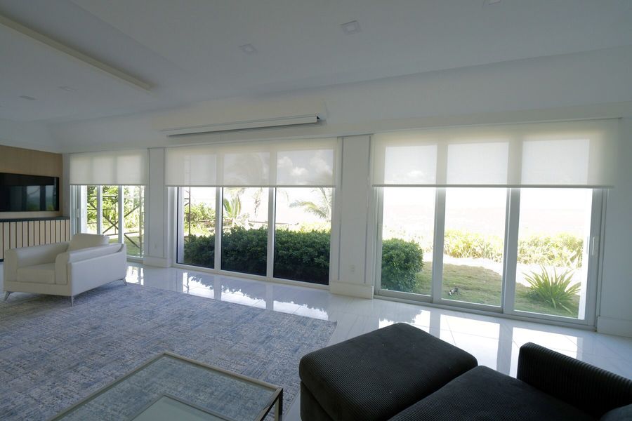 Basketweave 90 Bright White solar shades across the oceanfront living room glass on Hillsboro Mile