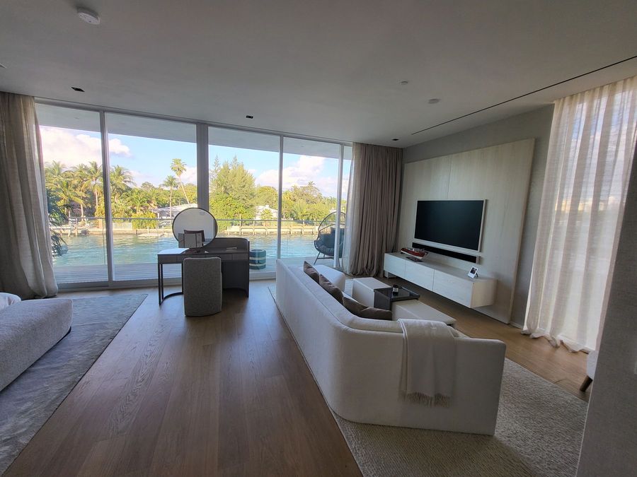 Living room with motorized sheer draperies and a water view, Ritz-Carlton Residences Miami Beach