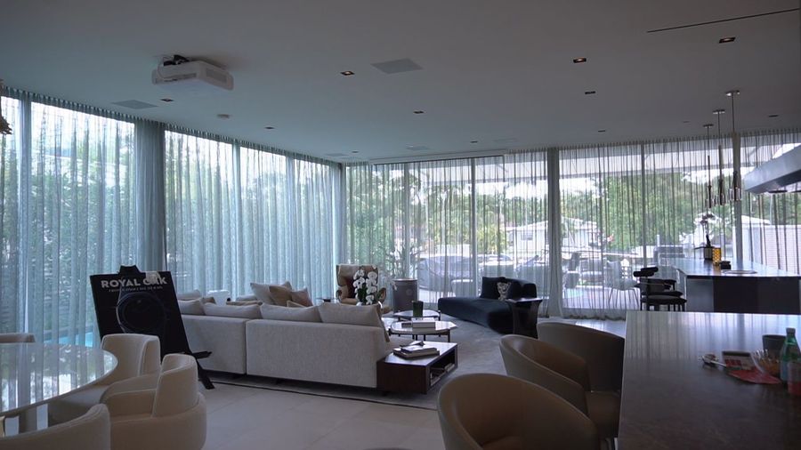 Ripplefold sheers drawn across a full wall of glass over the water, Ritz-Carlton Residences Miami Beach