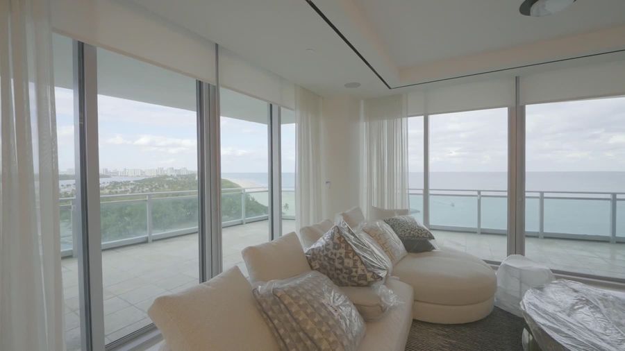 Highland blackout shade rolling up off corner glass to the bay view, Ritz-Carlton Residences Sunny Isles Beach