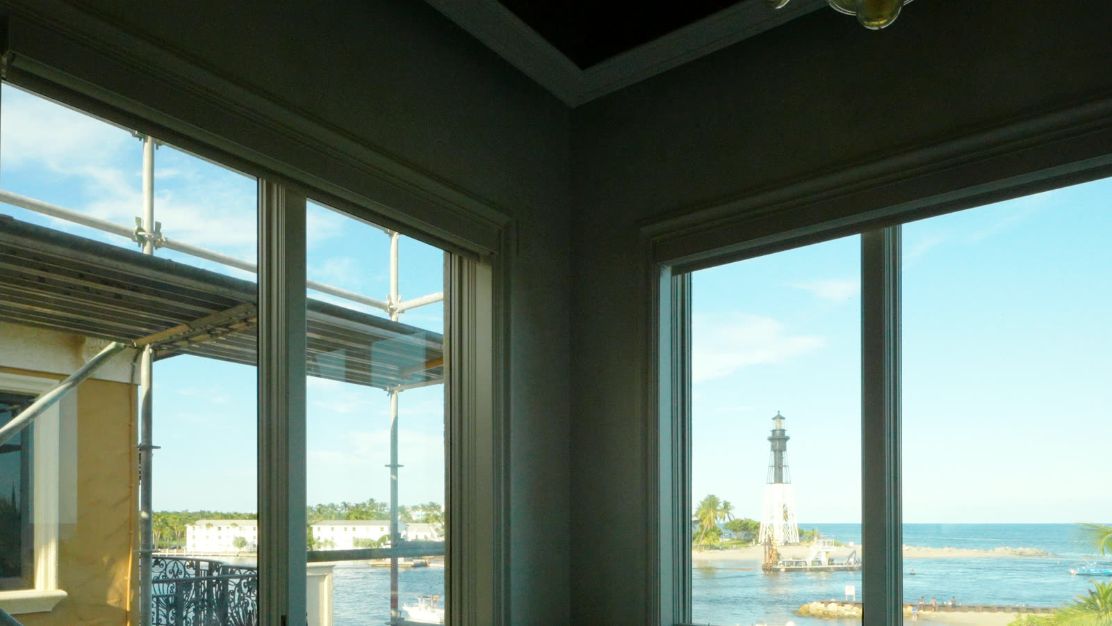 The picture window looking straight at the Hillsboro Inlet lighthouse, the blackout shade starting down
