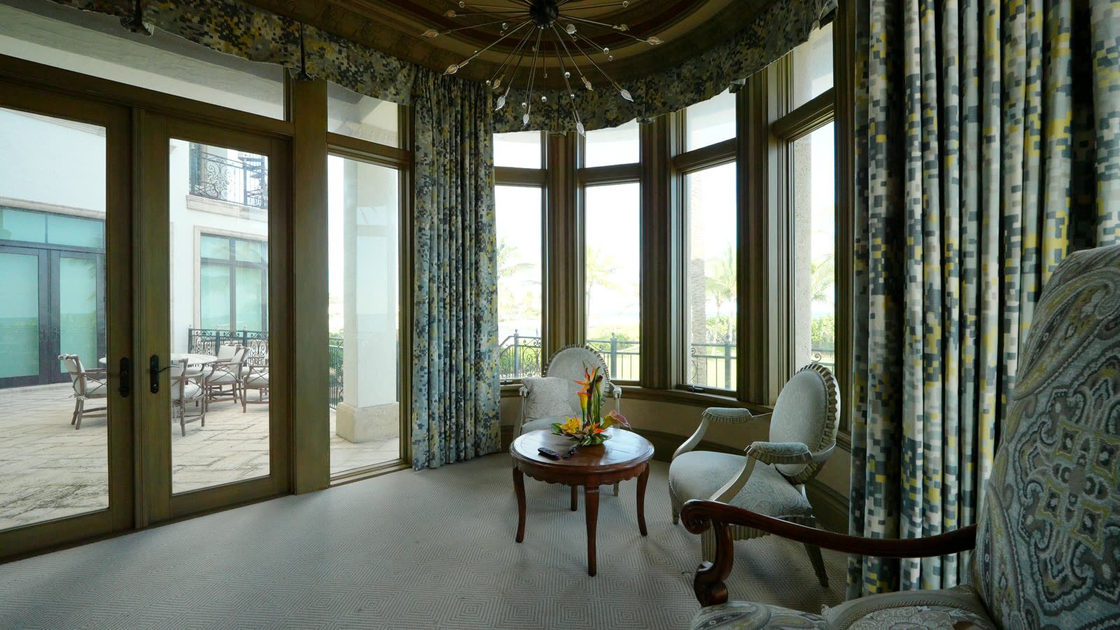 Master bedroom bay window sitting area with Kravet Design 34697-521 drapery panels, shades up on the terrace