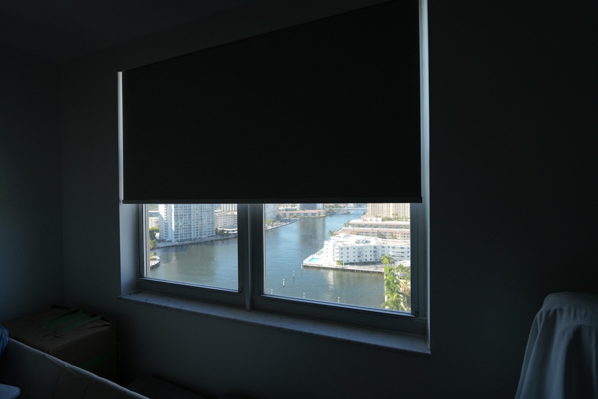 Blackout roller shade at mid height over an Intracoastal and marina view, Hallandale Beach