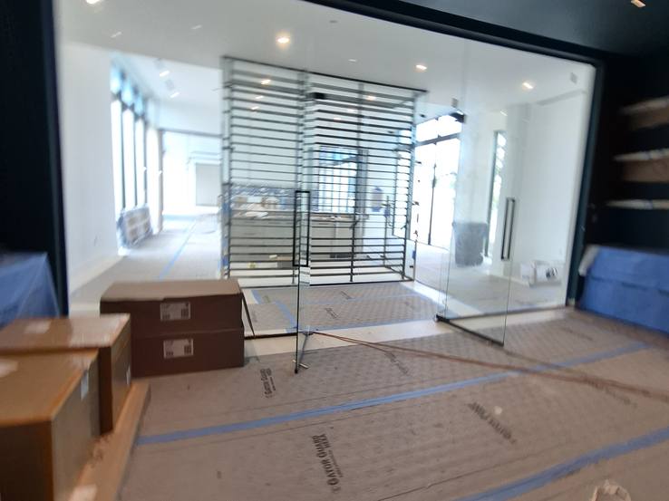 The unfinished theatre with its glass partition and the shelves beyond