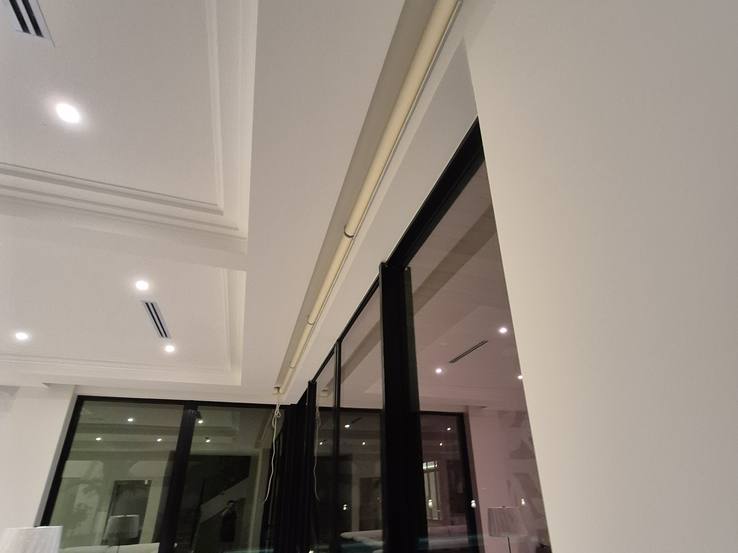 A drapery track fitted inside the ceiling pocket before the drapery went up