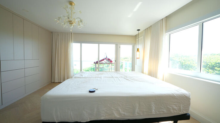 Master bedroom with the Kravet linen drapery open and the blackout rollers up
