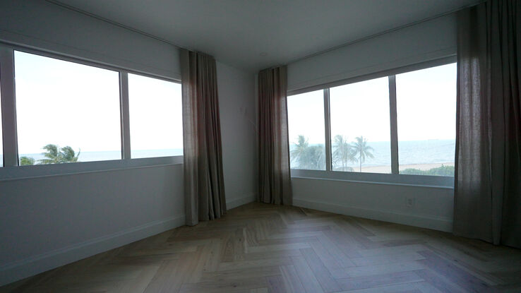Second bedroom with the Toronto Flax drapery stacked and both windows open to the palms and the ocean
