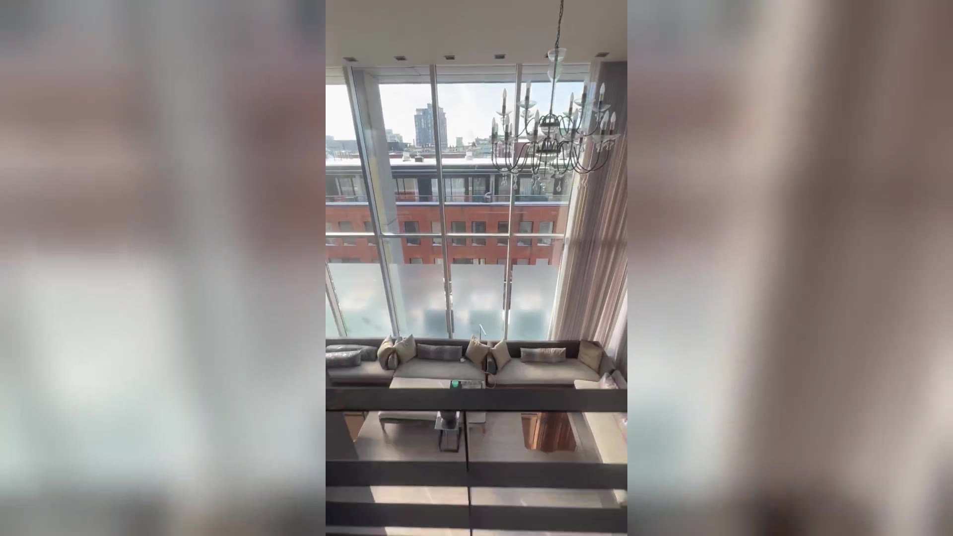 Penthouse bedroom with motorized sheer curtains and the Montreal skyline