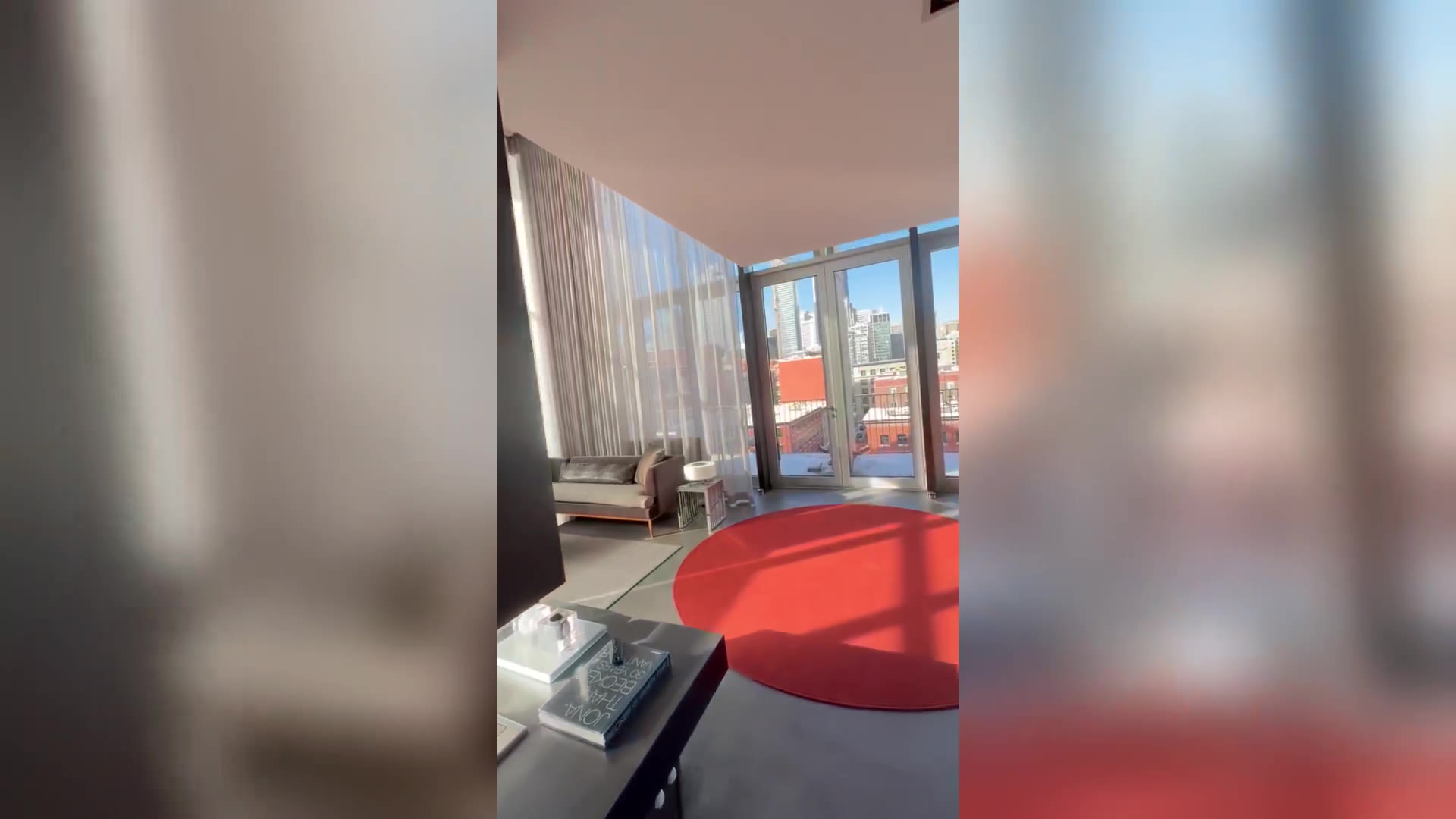 Double-height living room with motorized sheers on Somfy Glydea tracks in an Old Port Montreal penthouse