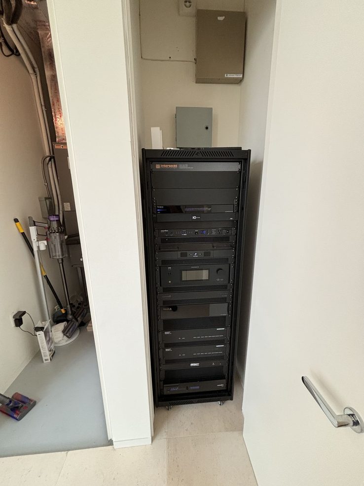 Lutron control equipment rack serving the residence's shading and lighting