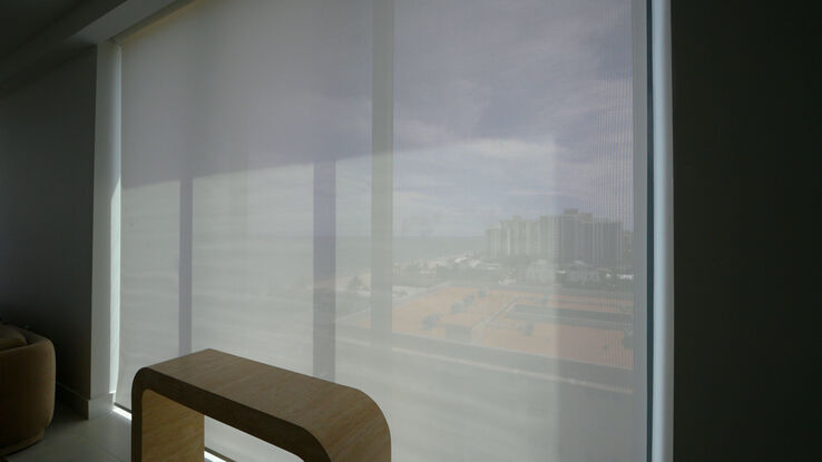 Dining window with the E Screen 3% shade down, the neighbouring buildings soft through the screen