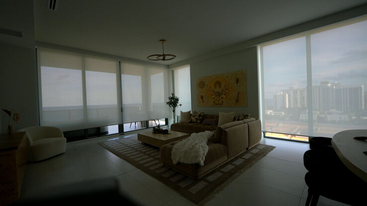 Living room with the E Screen 5% shades down and the ocean still visible through them