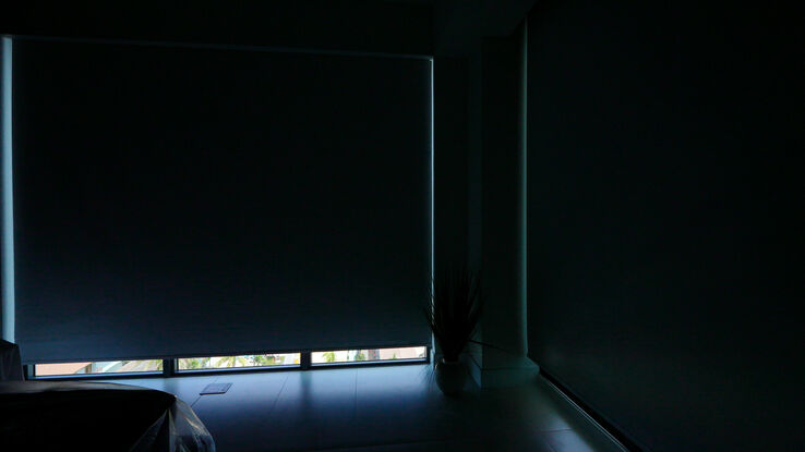 Master bedroom with the Sparta Twilight blackout shades almost fully down over the ocean corner