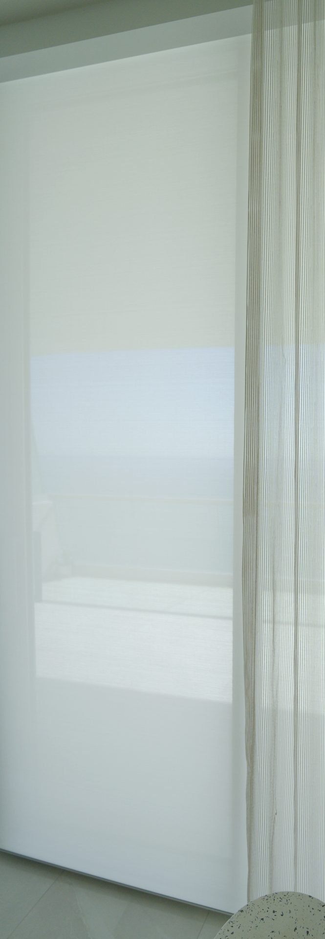 Mermet E-Screen 5% White Linen solar shade fabric installed at the glass