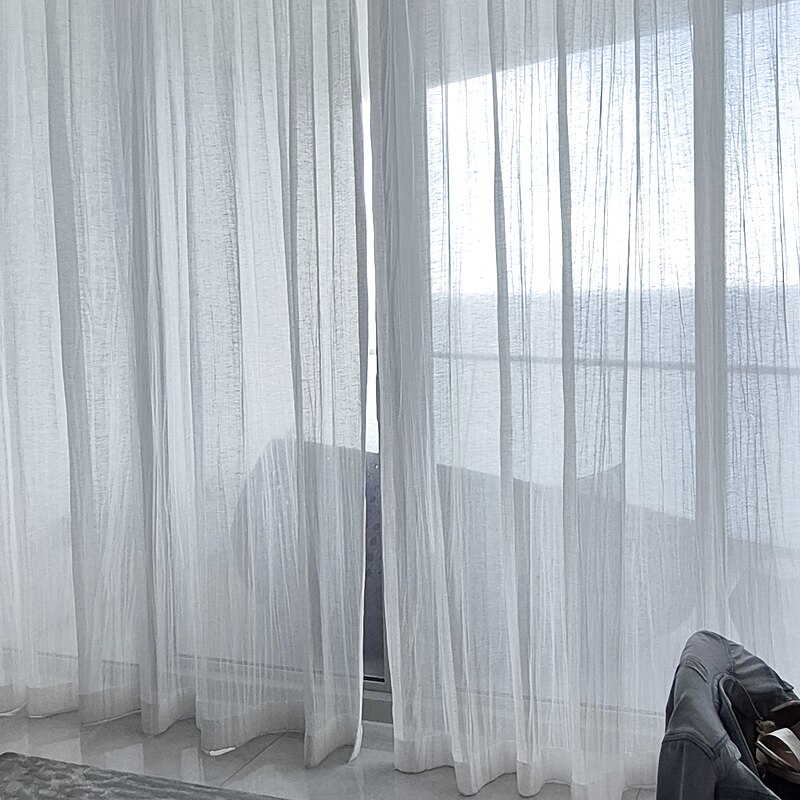 White Fabricut sheer drapery installed on a Crestron motorized track in the primary suite
