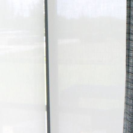 Coulisse Paris 3% solar screen in Gardenia lowered behind the office drapery