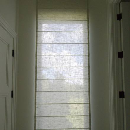 Flat Roman shade in Kravet Basics Silken Textures at the end of a hallway