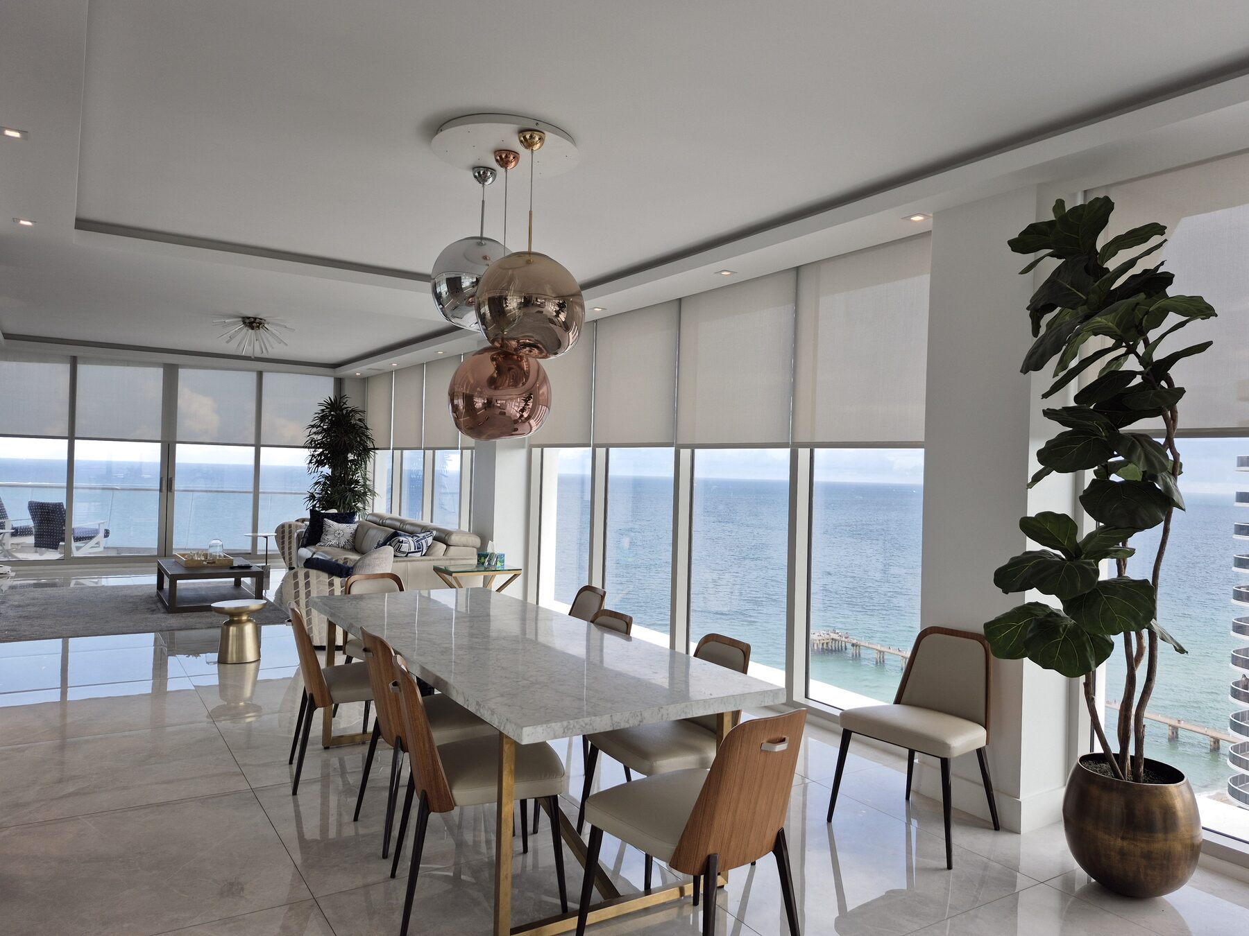 Dining room looking down the length of the residence with every shade pocketed into the ceiling