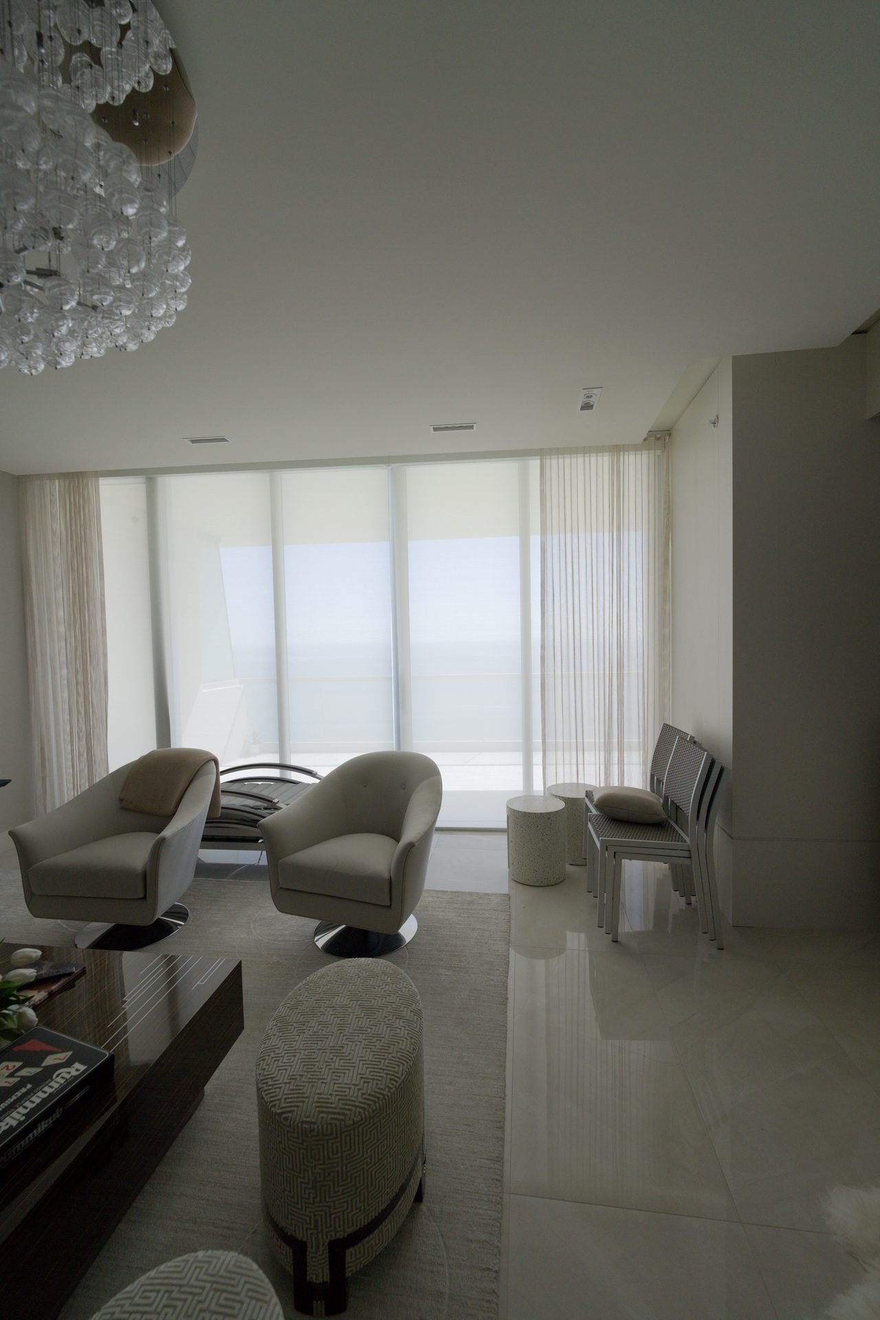 Living room solar shades and sheer drapery over the balcony at Turnberry Ocean Club