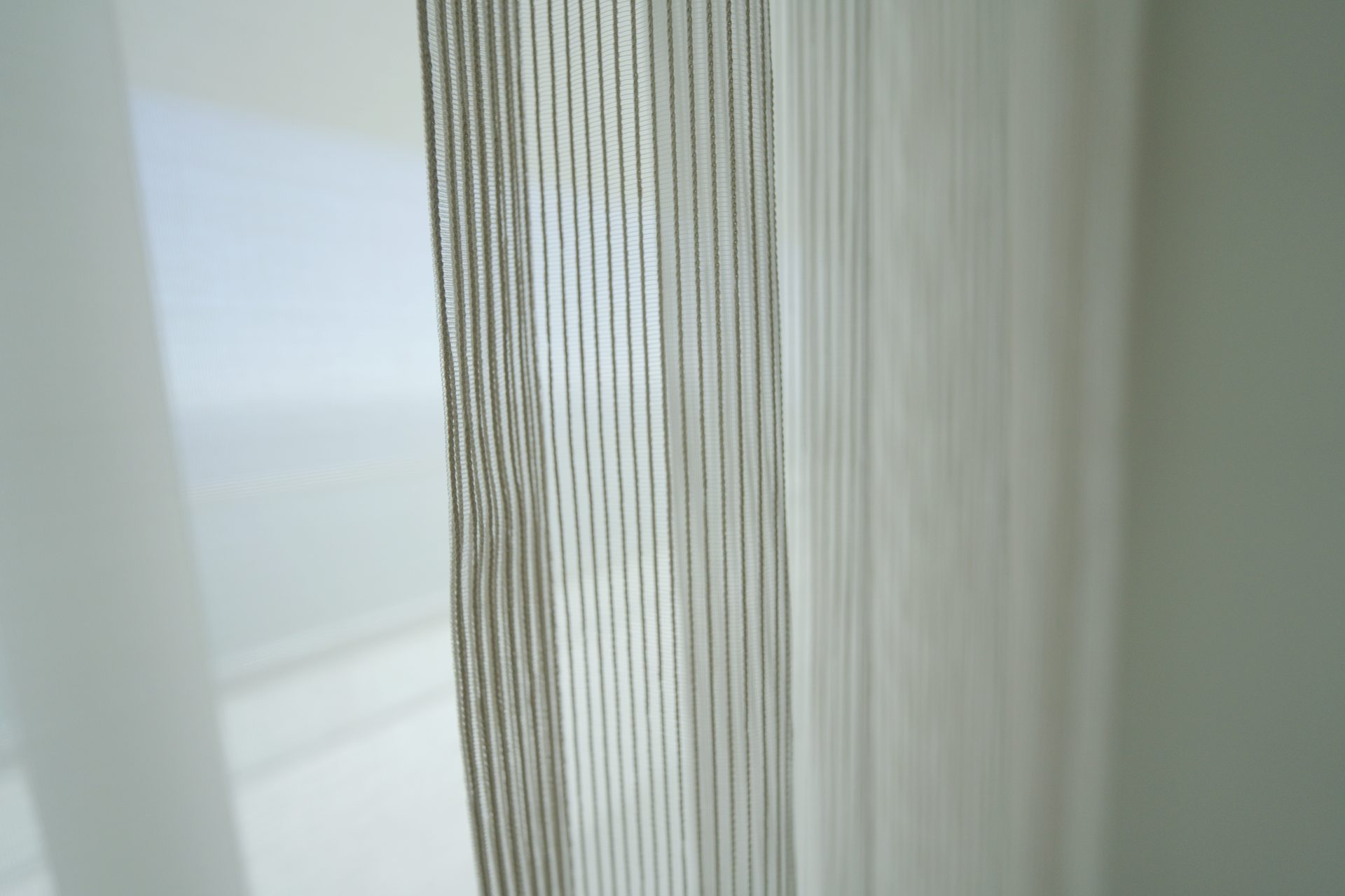 Romo Zyla Porcelain semi-sheer close up showing the textured weave at the glass