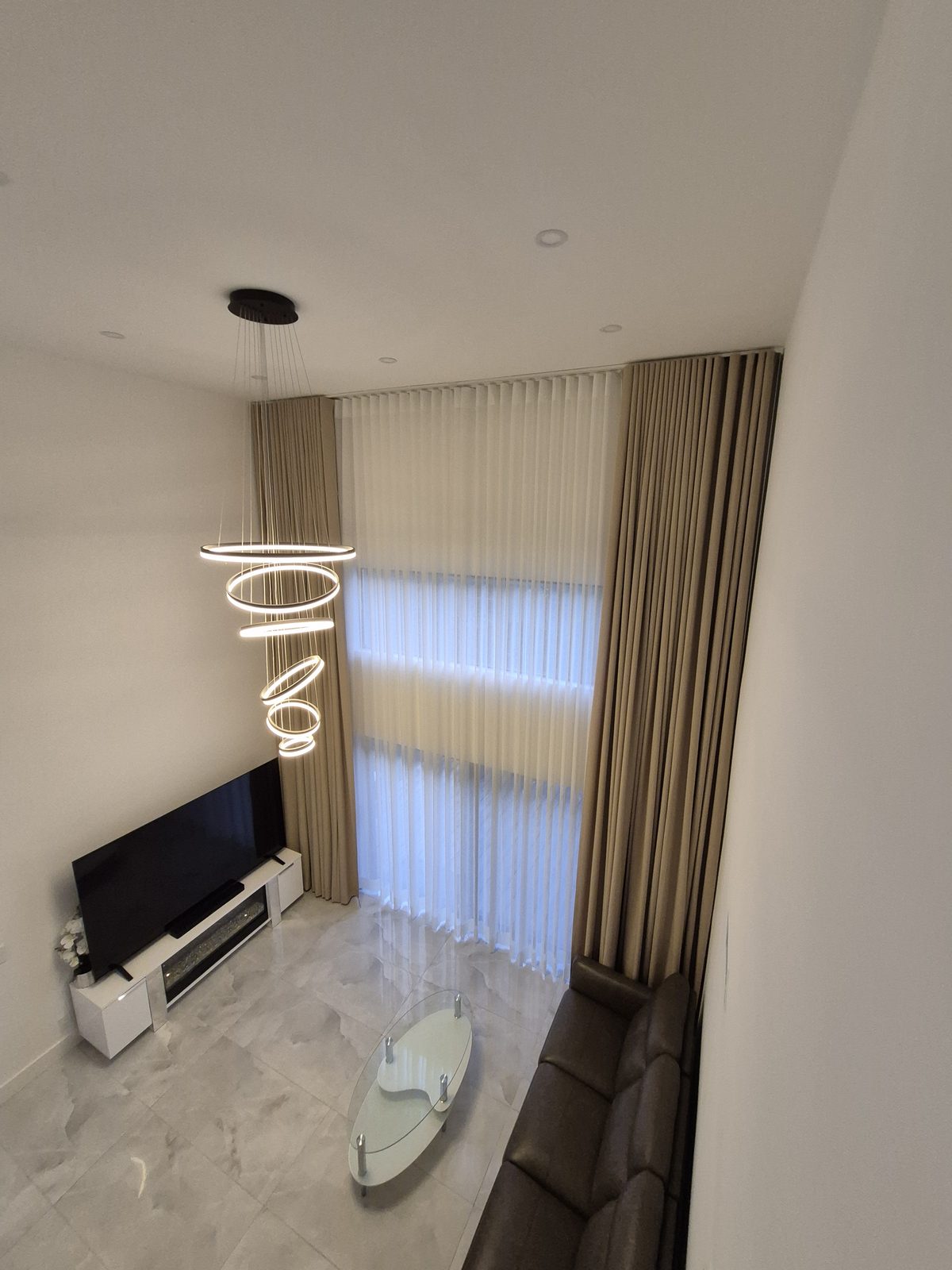Two-story sheer and drapery on two ceiling tracks, seen from the upper floor